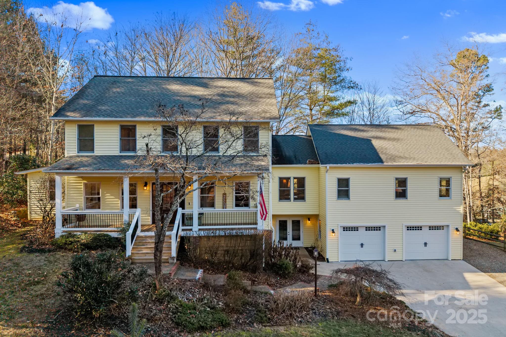 22 Sunset Lane Alexander, NC 28701 - Photo 1 of 48 a view of a white house with large windows and a small yard