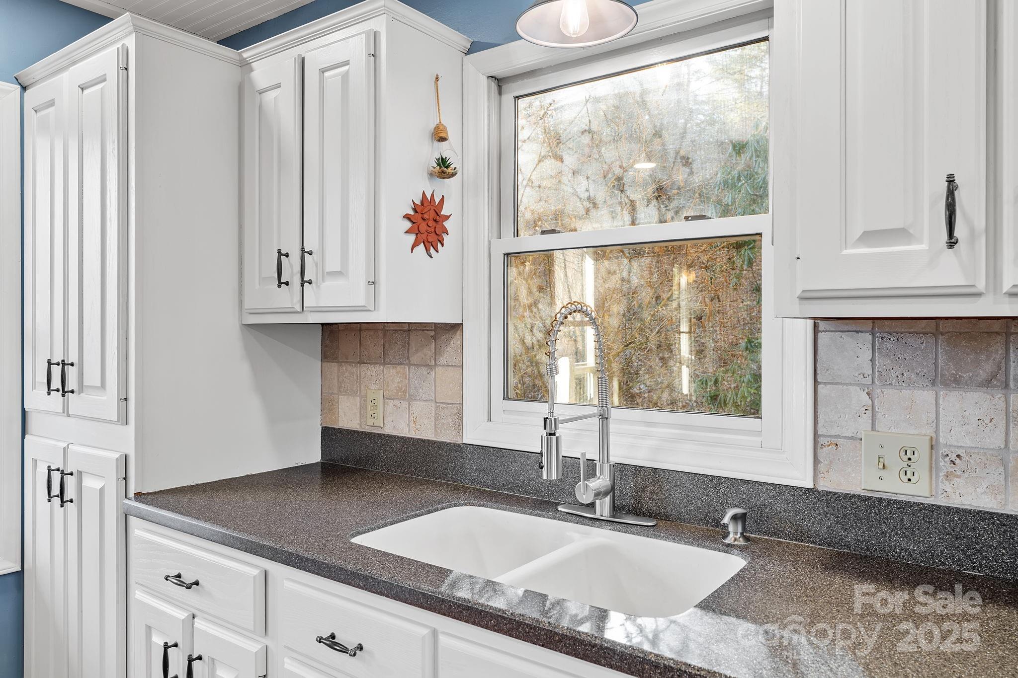 22 Sunset Lane Alexander, NC 28701 - Photo 13 of 48 a kitchen with granite countertop a sink a window and a granite counter tops