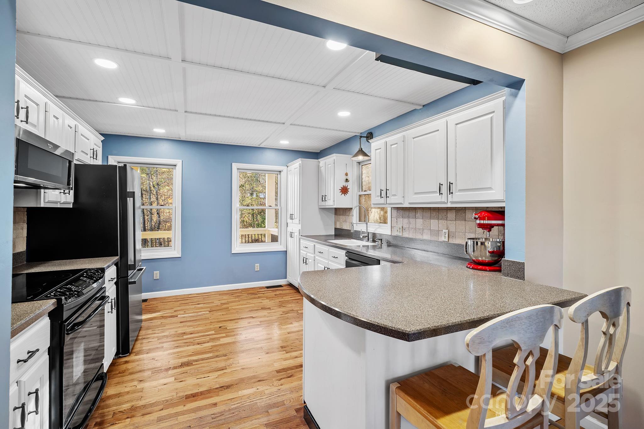 22 Sunset Lane Alexander, NC 28701 - Photo 14 of 48 a kitchen with stainless steel appliances granite countertop a sink stove microwave and cabinets