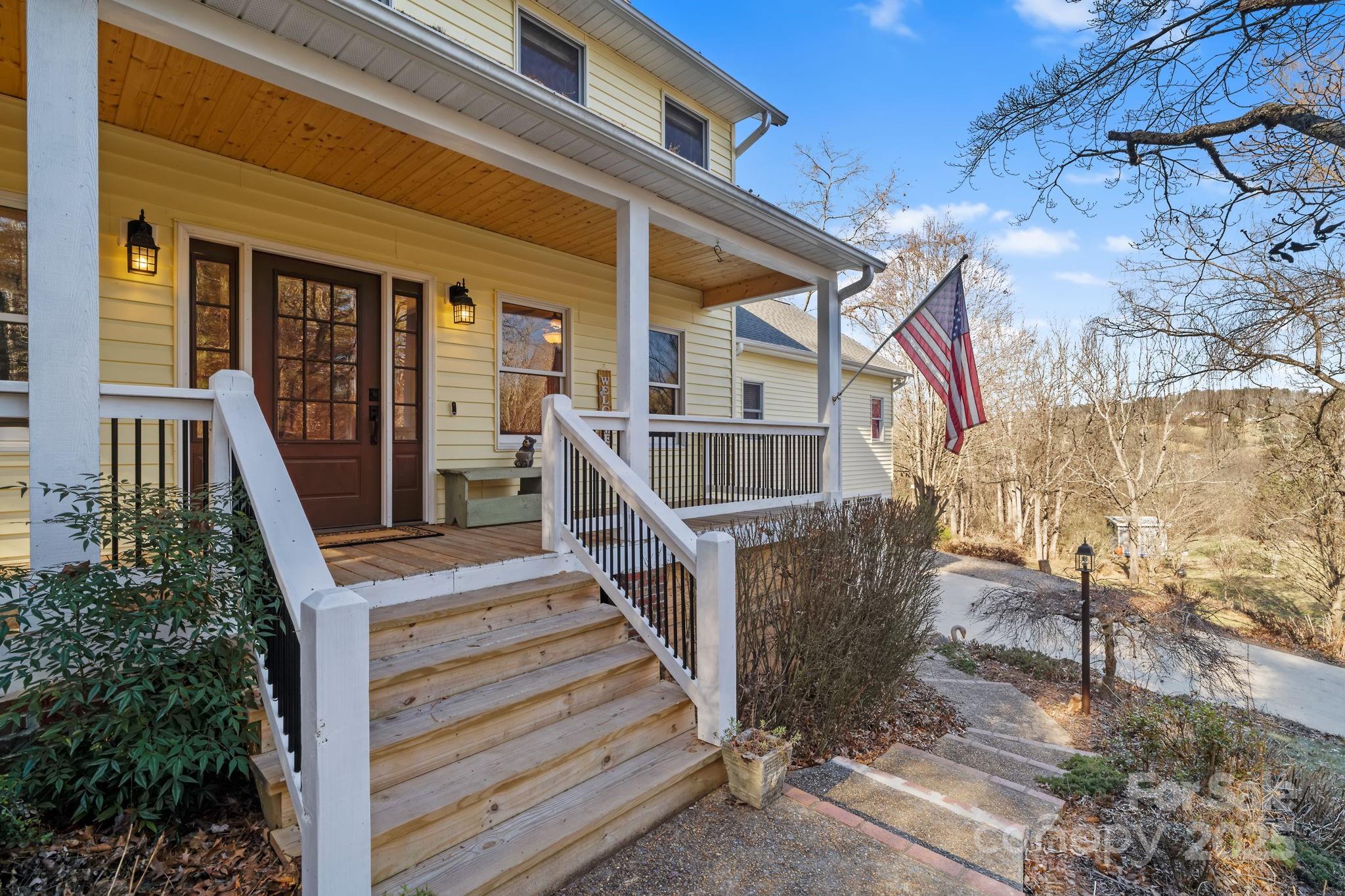 22 Sunset Lane Alexander, NC 28701 - Photo 2 of 48 a view of house with wooden stairs and a table and chairs