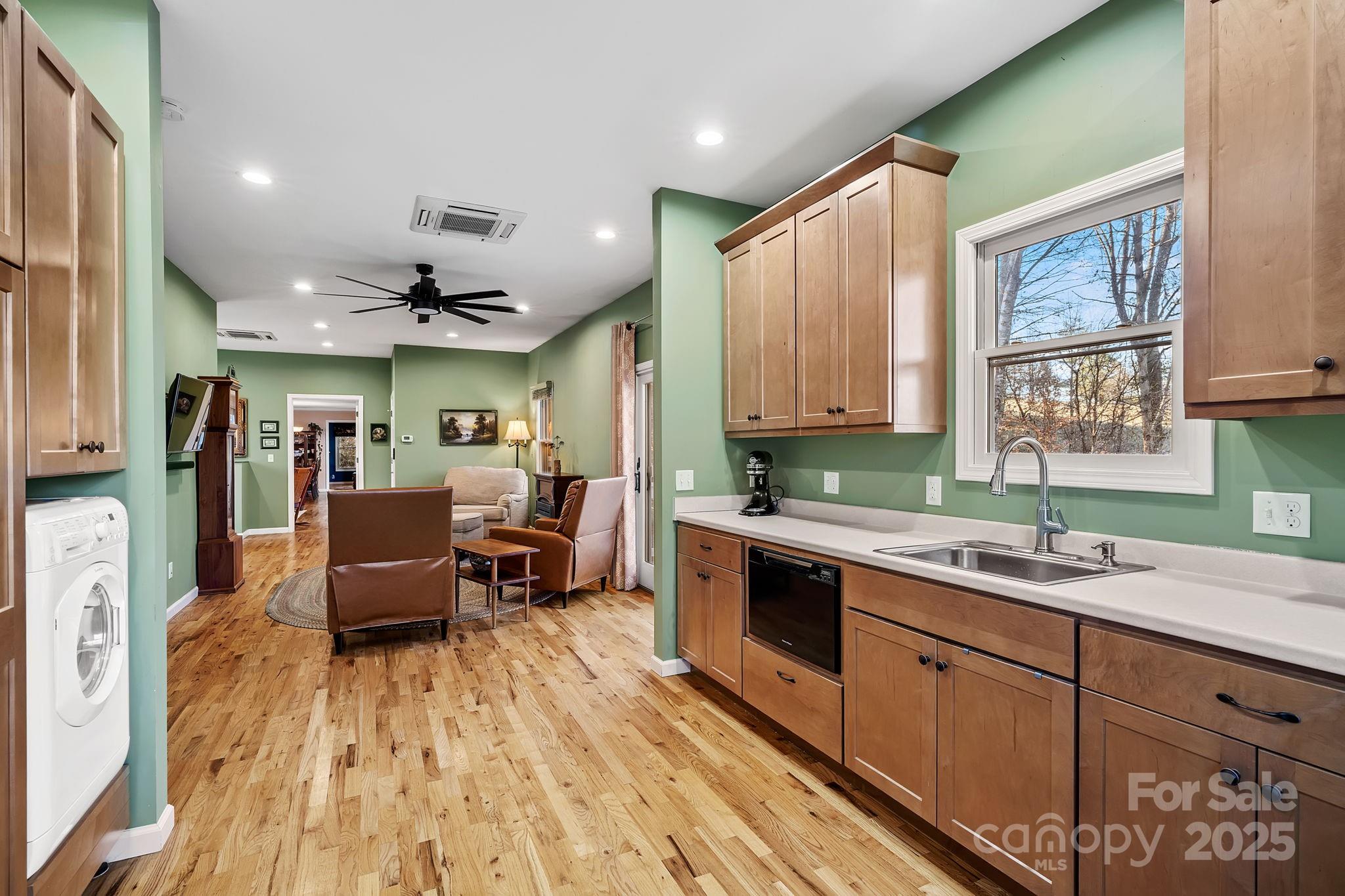 22 Sunset Lane Alexander, NC 28701 - Photo 25 of 48 a large white kitchen with wooden floor and stainless steel appliances