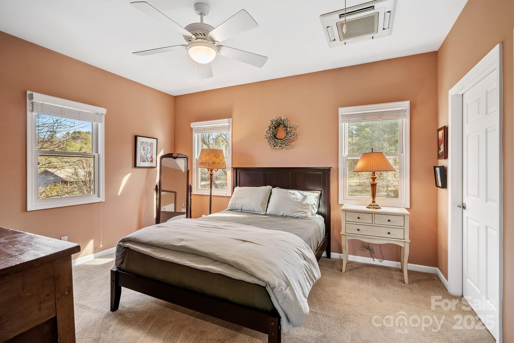 22 Sunset Lane Alexander, NC 28701 - Photo 28 of 48 a bedroom with a bed and a chandelier