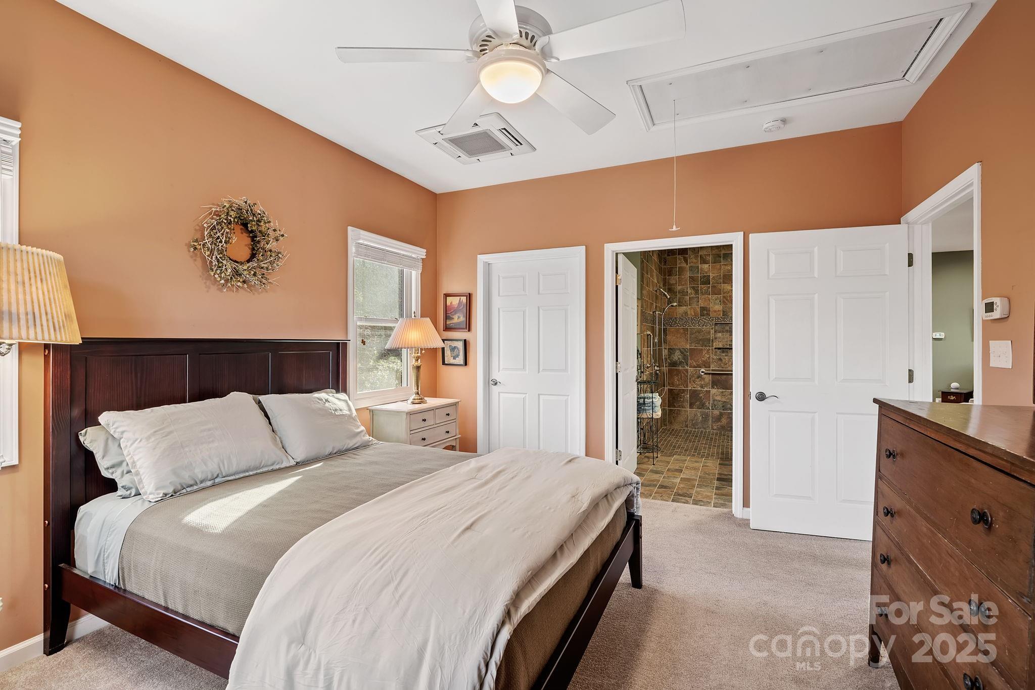22 Sunset Lane Alexander, NC 28701 - Photo 29 of 48 a bedroom with a bed and a chandelier