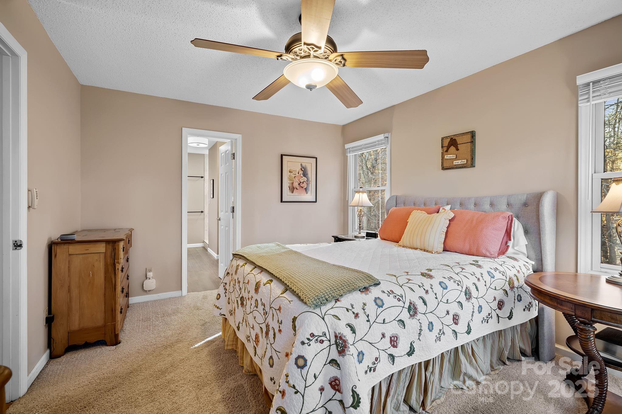 22 Sunset Lane Alexander, NC 28701 - Photo 32 of 48 a bedroom with a bed and a chandelier