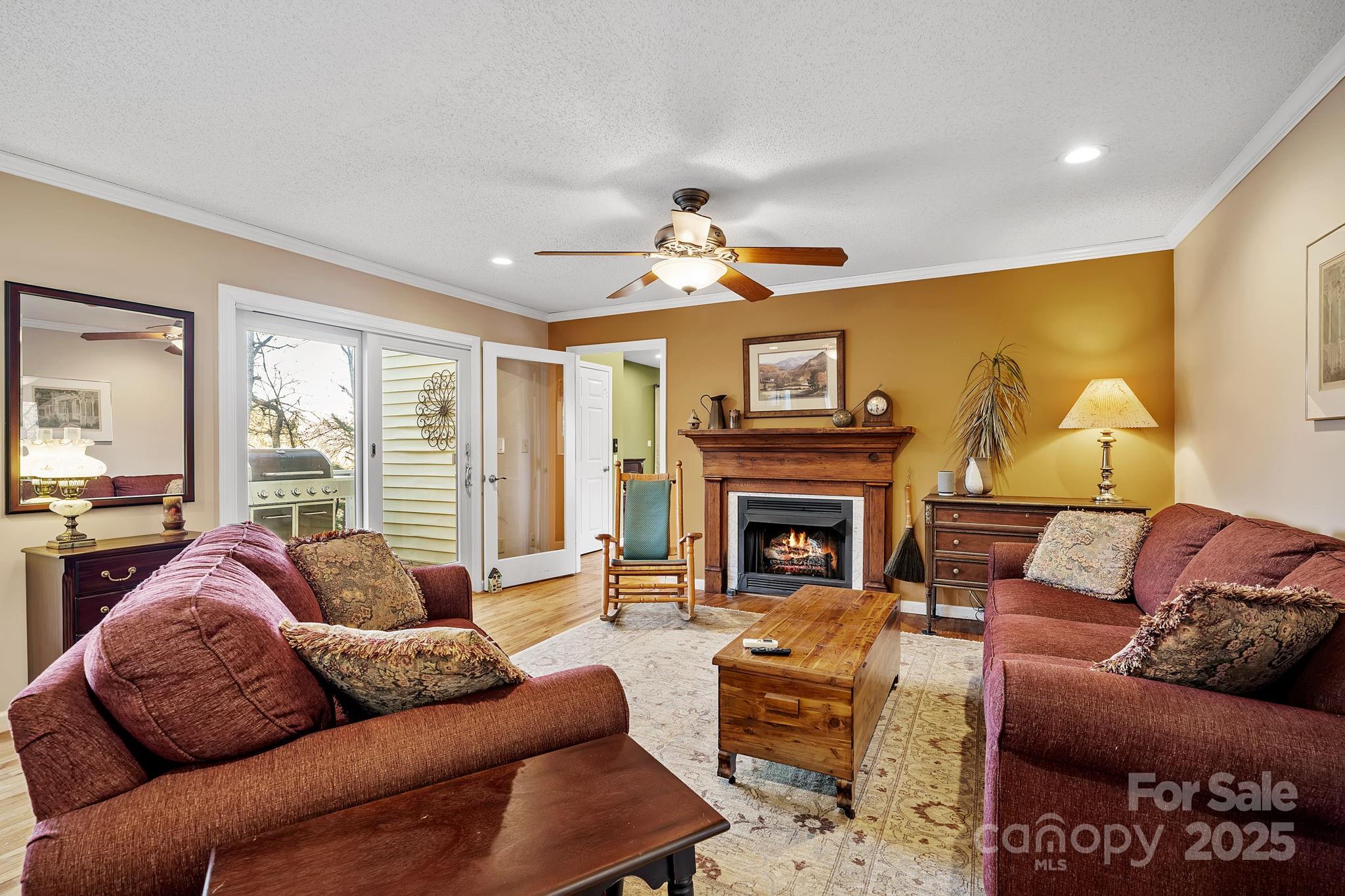 22 Sunset Lane Alexander, NC 28701 - Photo 8 of 48 a living room with furniture a fireplace and a large window