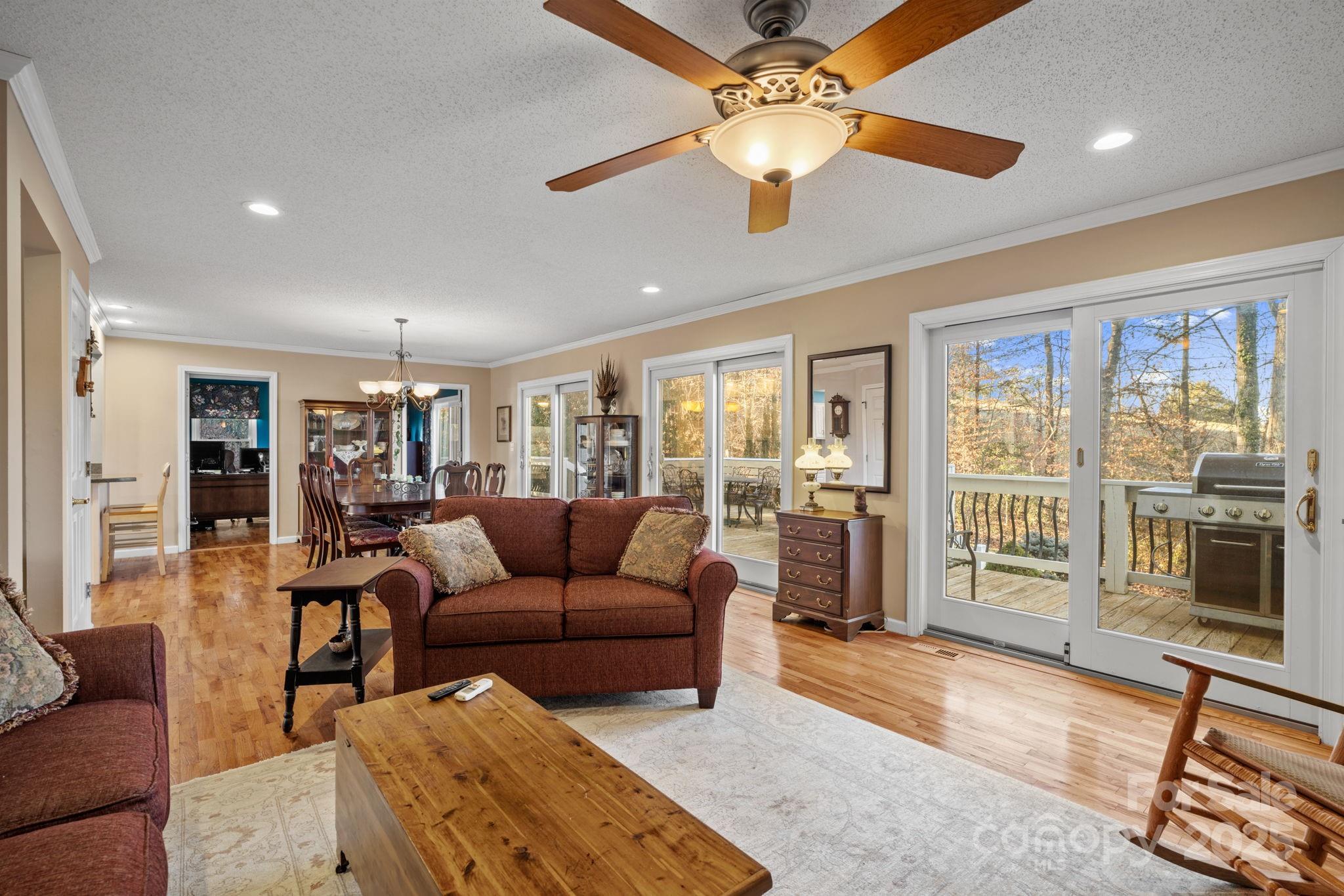 22 Sunset Lane Alexander, NC 28701 - Photo 9 of 48 a living room with furniture a flat screen tv and a floor to ceiling window