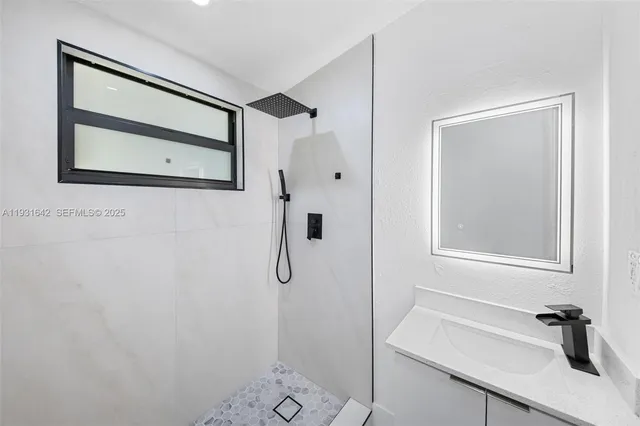 a bathroom with a shower and a mirror