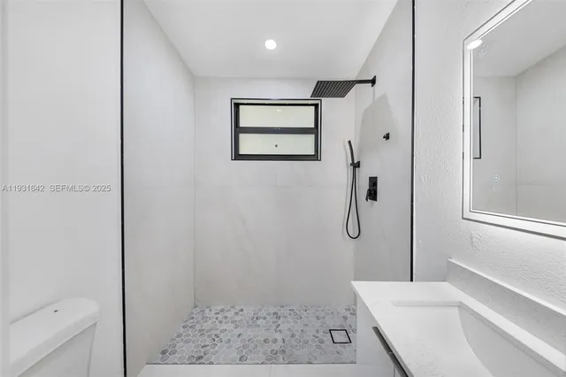 a bathroom with a shower and a toilet