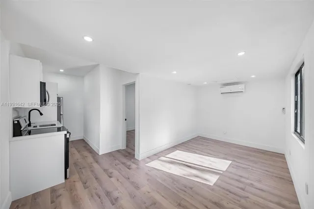 a view of a kitchen with a sink and a refrigerator