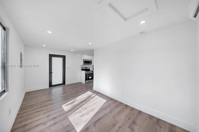 an empty room with wooden floor and closet