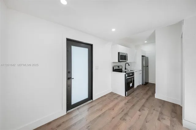 a kitchen with stainless steel appliances a refrigerator and a stove top oven