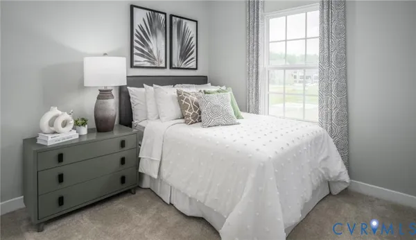 a large bed sitting in a bedroom next to a window