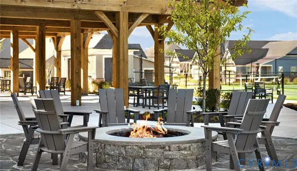 a view of a dining room with furniture large windows and wooden floor