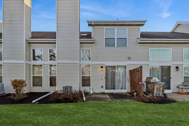 a front view of a house with a garden and yard