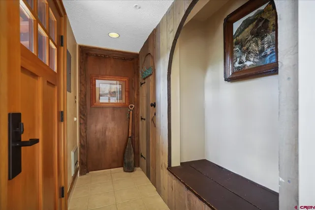 a view of a hallway with wooden floor and closet