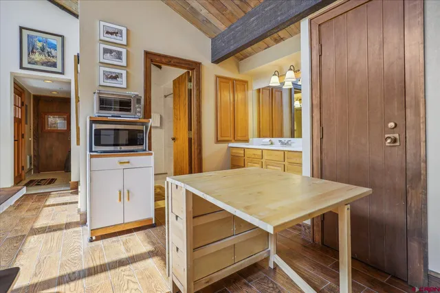 a kitchen that has a table and chairs in it