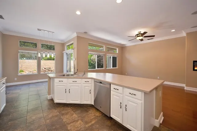 a spacious bathroom with a granite countertop sink a large mirror and a bathtub