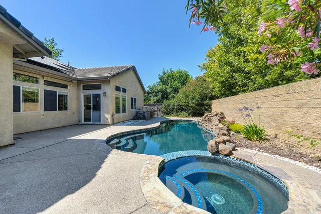 swimming pool view with a seating space