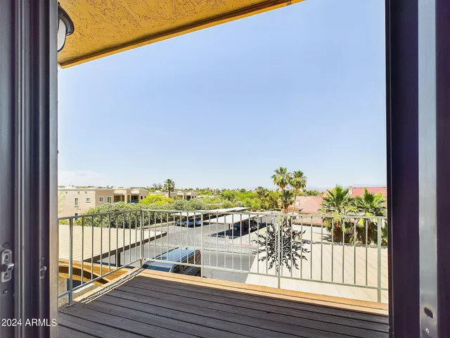 a view of balcony with wooden floor and city view