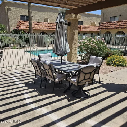 a view of a chairs and table in a patio