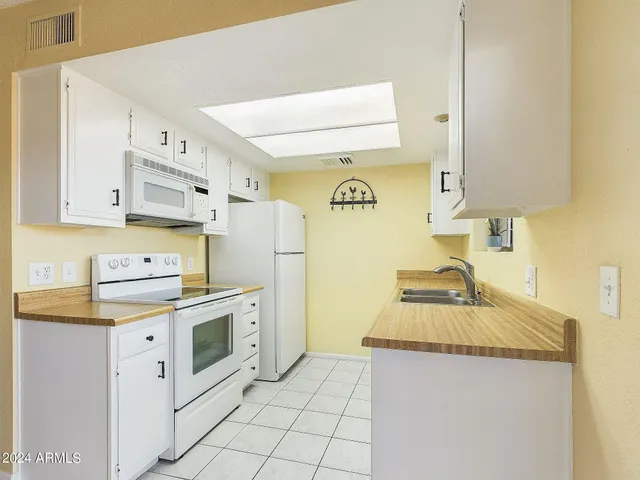 a kitchen with cabinets appliances and a counter top space
