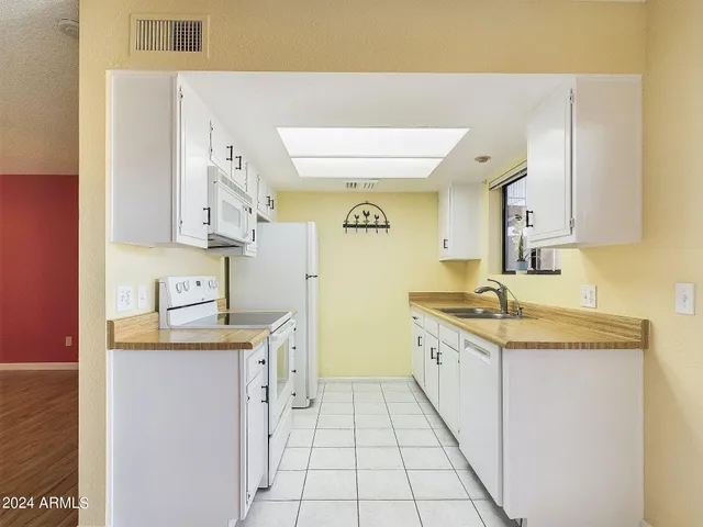 a kitchen with stainless steel appliances granite countertop a sink and cabinets