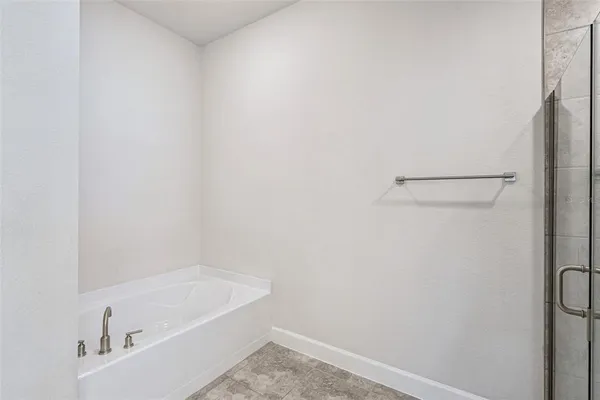 a bathroom with a tub and a sink