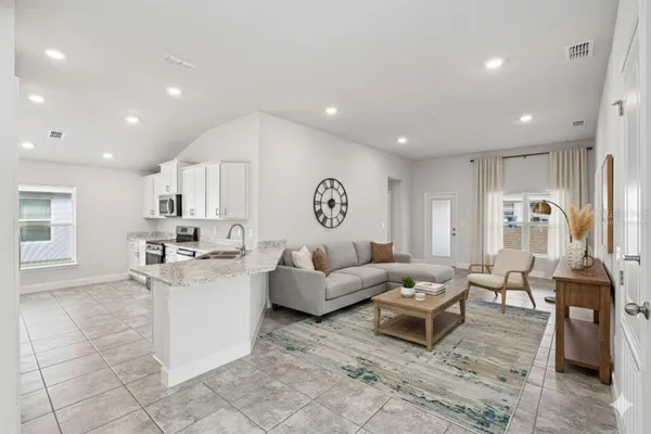 a living room with furniture and a chandelier