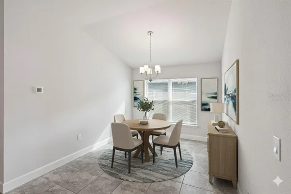 a view of a dining room with furniture and chandelier