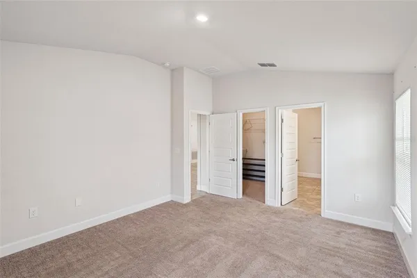 a view of an empty room with a bathroom