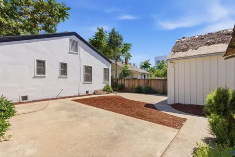 a backyard of a house with plants and trees