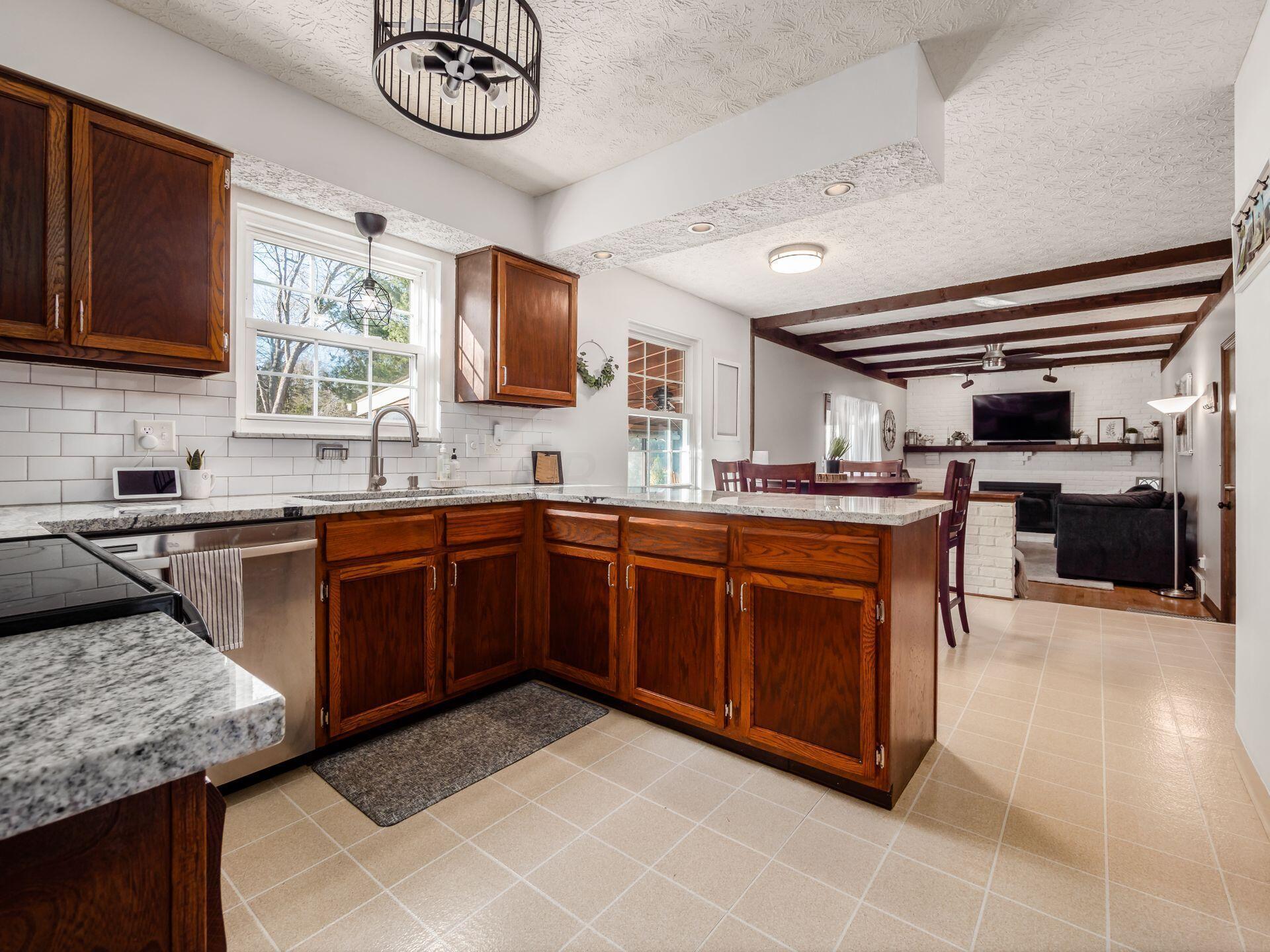 61 Somerset Road Delaware, OH 43015 - Photo 6 of 28 Updated kitchen with granite and subway tiles. All open to dinette and family room.