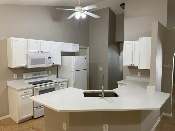 a kitchen with stainless steel appliances a stove a refrigerator and a refrigerator