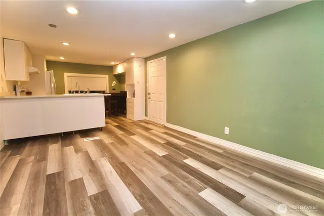 a view of room with wooden floor