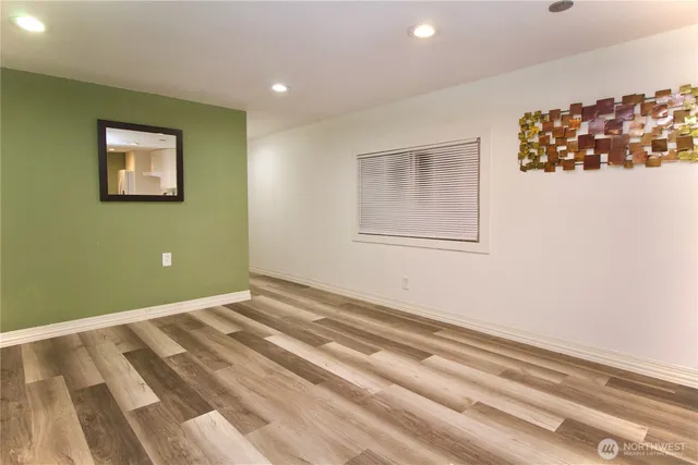 a view of room with wooden floor