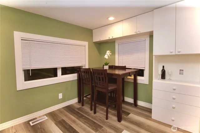 a view of a workspace with furniture and wooden floor