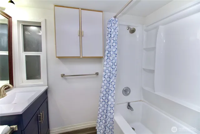 a bathroom with a bathtub and shower