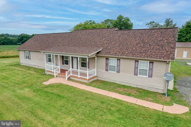 a aerial view of a house with a yard patio and fire pit