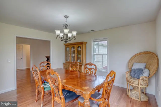 a view of a dining room with furniture and chandelier