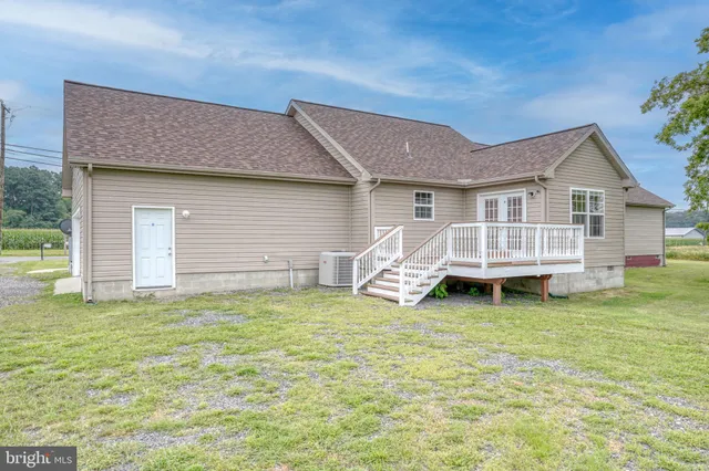 a view of a house with a yard and deck