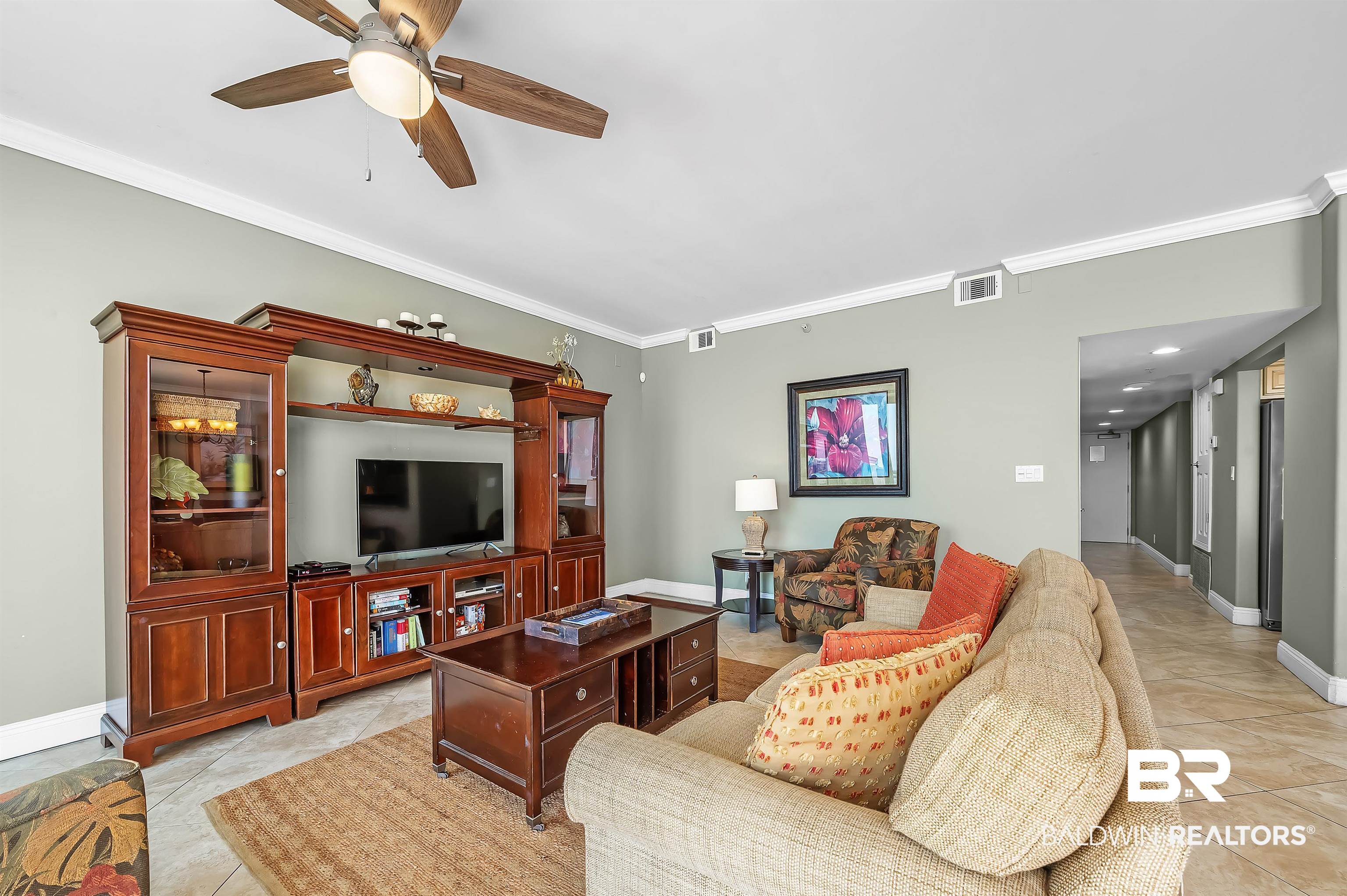 16287 Perdido Key Drive, Unit 105 Pensacola, FL 32507 - Photo 16 of 66 Spacious living area featuring light-toned walls and crown molding