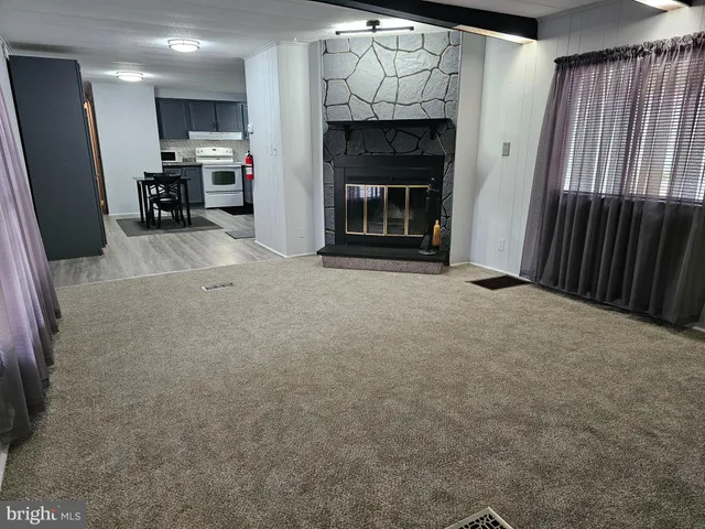 a view of an empty room with a fireplace