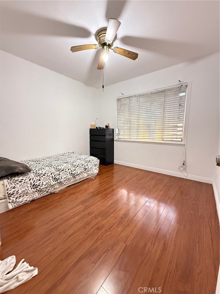 1427 South Rene Drive Santa Ana, CA 92704 - Photo 6 of 8 a view of an empty room with wooden floor and a window