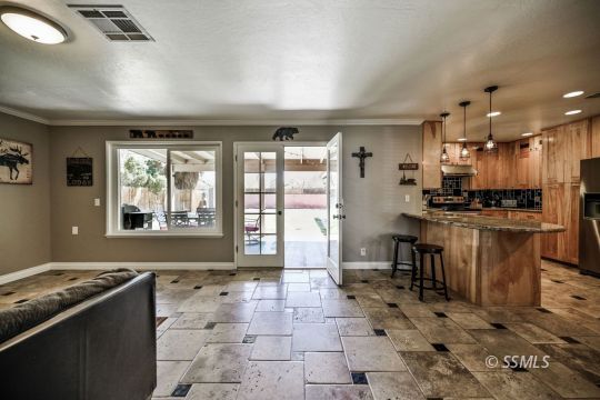 725 West Howell Avenue Ridgecrest, CA 93555 - Photo 22 of 35 a kitchen with granite countertop a stove a sink and a refrigerator