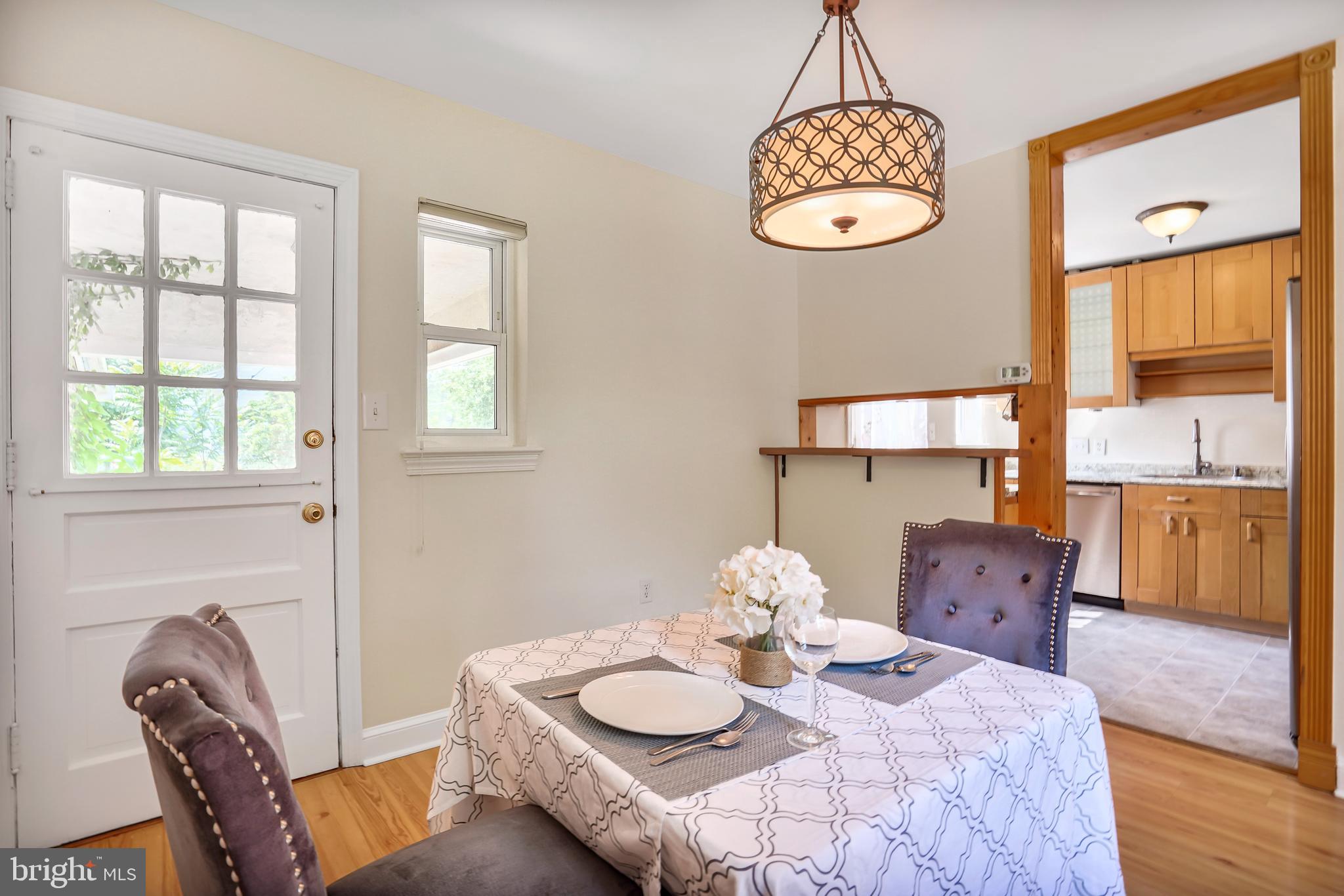 7110 Coventry Road Alexandria, VA 22306 - Photo 8 of 42 a view of a dining room with furniture window and wooden floor