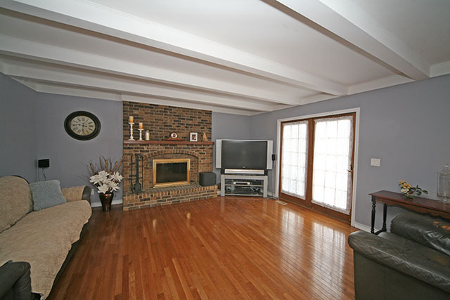 2110 Fairfax Road St. Charles, IL 60174 - Photo 14 of 20 a living room with furniture a fireplace and a flat screen tv