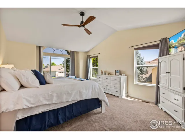 a living room with a bed furniture and a flat tv screen