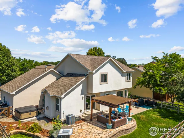 a view of a white house with a big yard and a large tree