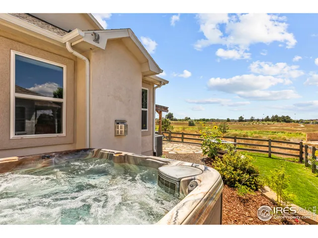 a view of a terrace with wooden floor and a yard