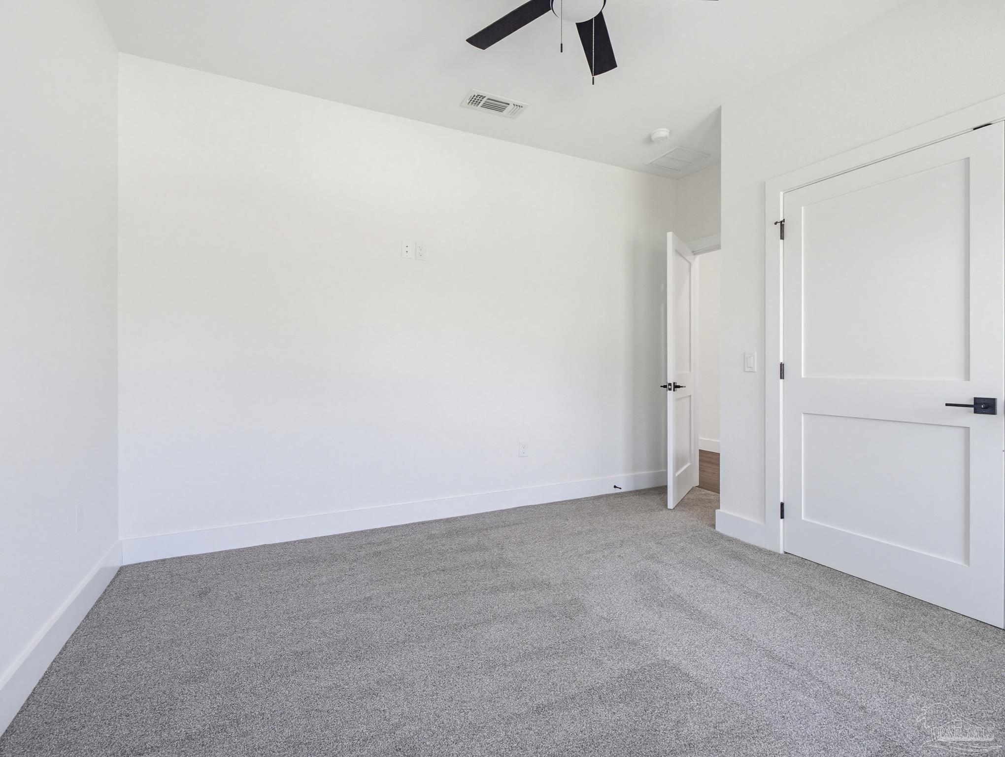 5724 Riviera Drive Milton, FL 32583 - Photo 7 of 52 an empty room with ceiling fan and window